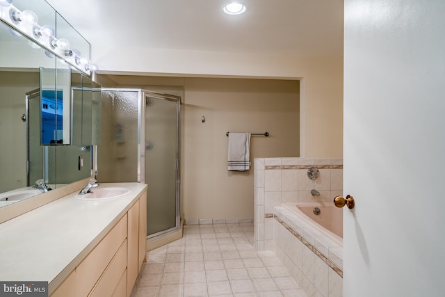 bathroom featuring independent shower and bath, tile floors, and vanity with extensive cabinet space