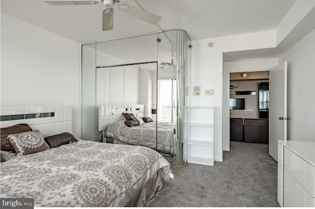 carpeted bedroom featuring a closet and ceiling fan