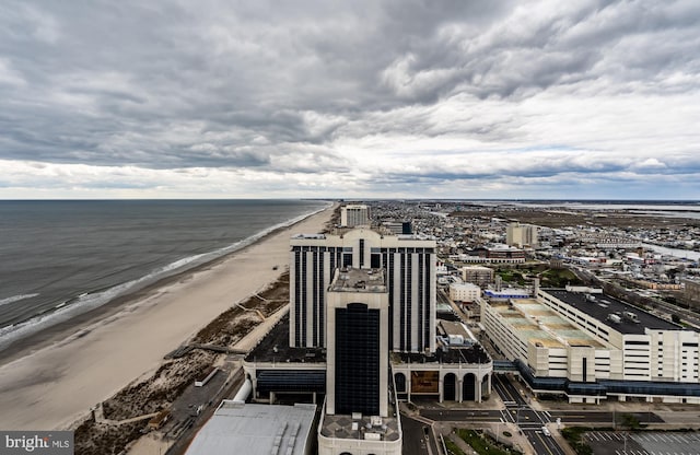 birds eye view of property with a beach view and a water view