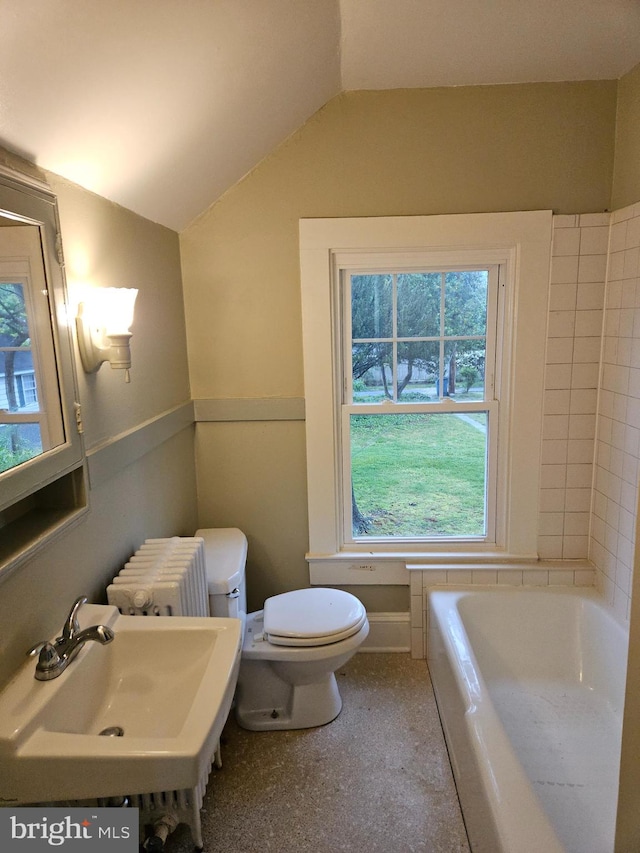 bathroom with vaulted ceiling, toilet, radiator heating unit, a healthy amount of sunlight, and sink