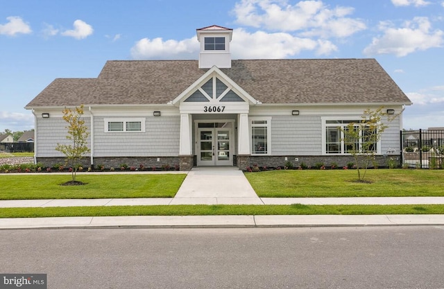 craftsman inspired home with a front lawn