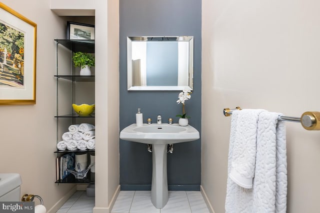 bathroom featuring toilet and tile patterned flooring