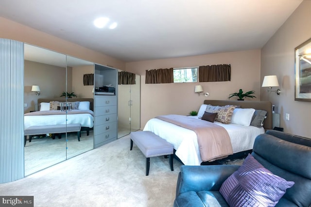 bedroom with a closet and light colored carpet