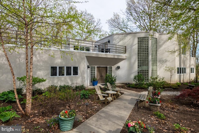 view of front of house with a patio and a balcony