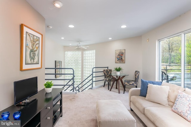 living room with light carpet and ceiling fan