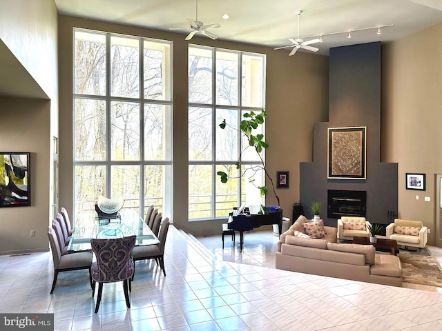 dining area with light tile patterned floors and ceiling fan