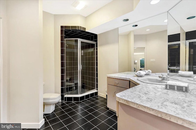 bathroom featuring a shower with door, vanity, toilet, and tile patterned floors