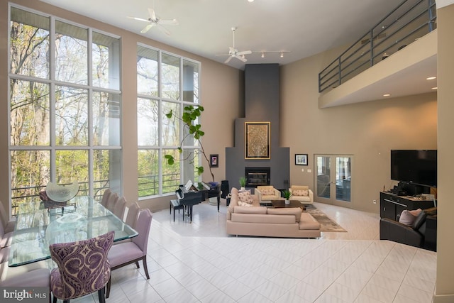 living room featuring ceiling fan and plenty of natural light