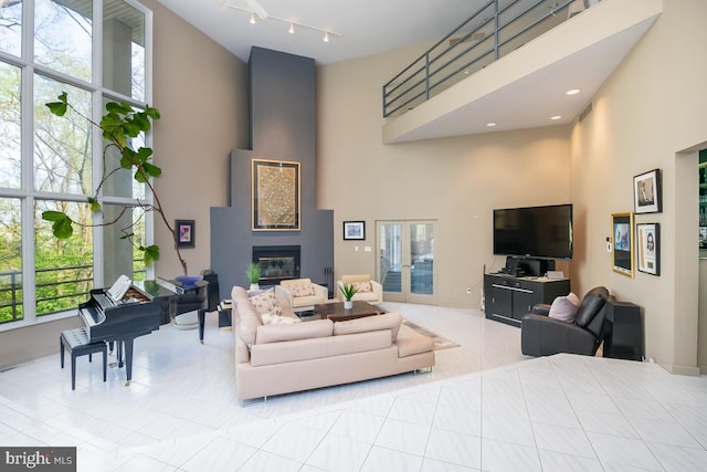 living room featuring a high ceiling and light tile patterned floors