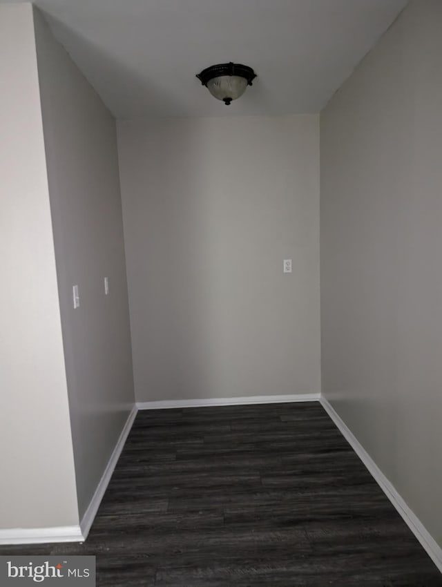 unfurnished room with dark hardwood / wood-style flooring