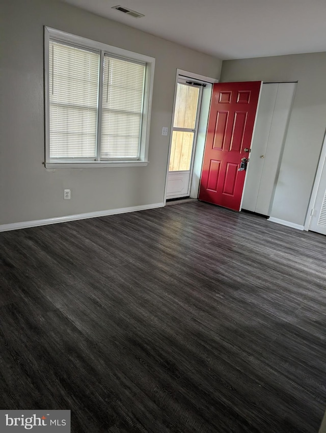 spare room with dark wood-type flooring