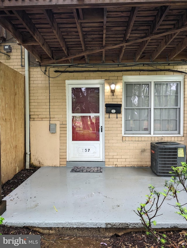 entrance to property featuring central air condition unit