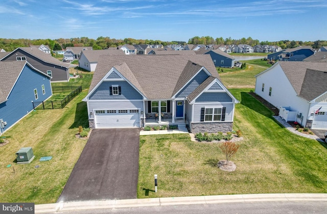 craftsman-style home featuring a garage and a front lawn