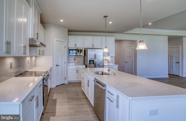 kitchen featuring white cabinetry, a center island with sink, stainless steel appliances, and sink