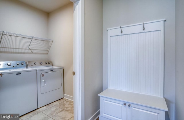 washroom featuring light tile patterned floors and washing machine and dryer