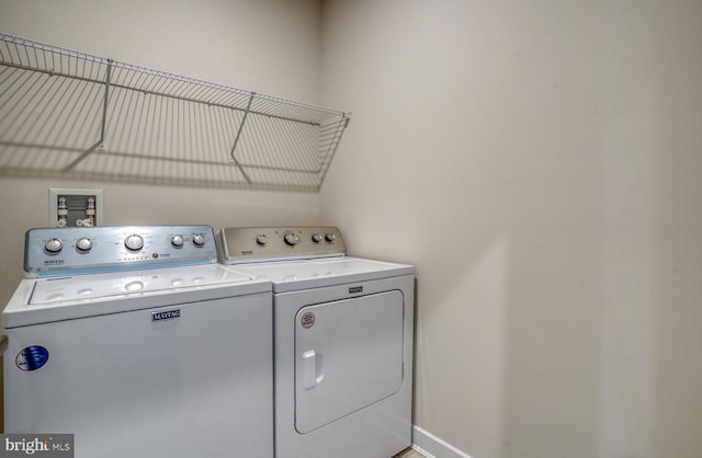 laundry room featuring washing machine and clothes dryer