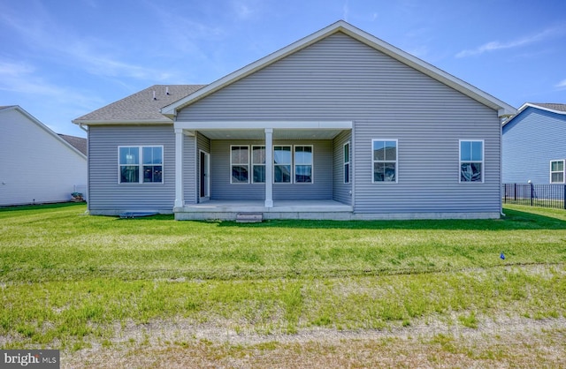 back of house with a lawn