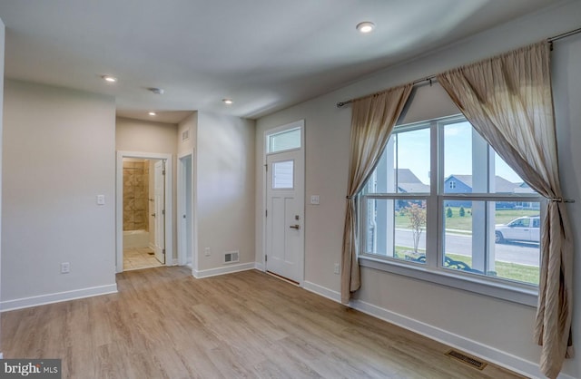 foyer entrance with light hardwood / wood-style floors