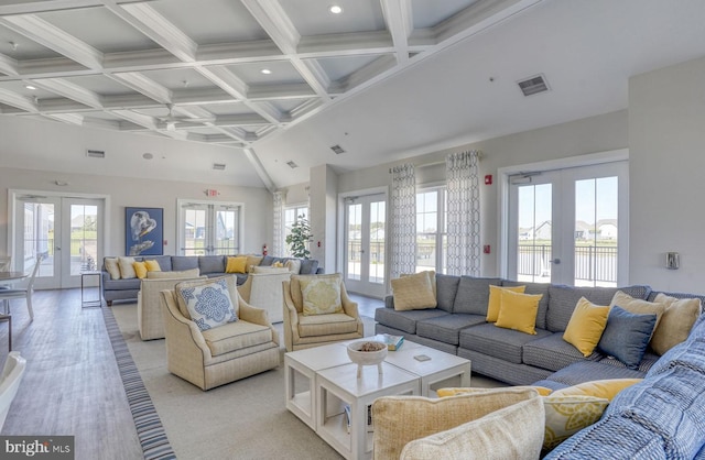 carpeted living room featuring coffered ceiling, beam ceiling, and french doors