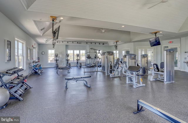 exercise room with high vaulted ceiling and ceiling fan