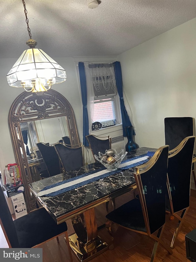 office space with a notable chandelier, a textured ceiling, and hardwood / wood-style floors