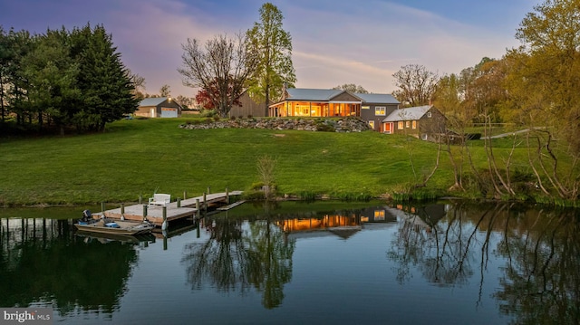 view of dock featuring a yard and a water view