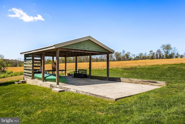 view of property's community with a yard and a patio area