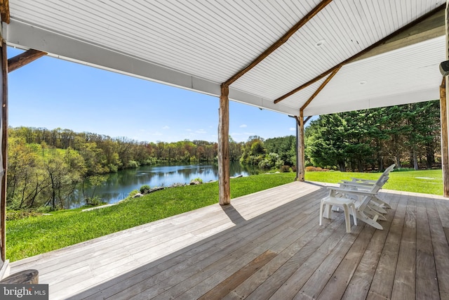 deck with a yard and a water view