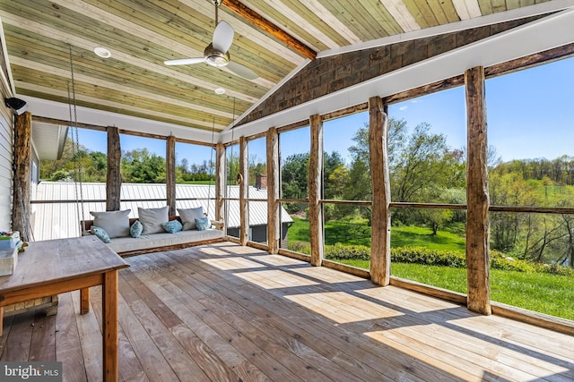 unfurnished sunroom with wood ceiling, a healthy amount of sunlight, and ceiling fan