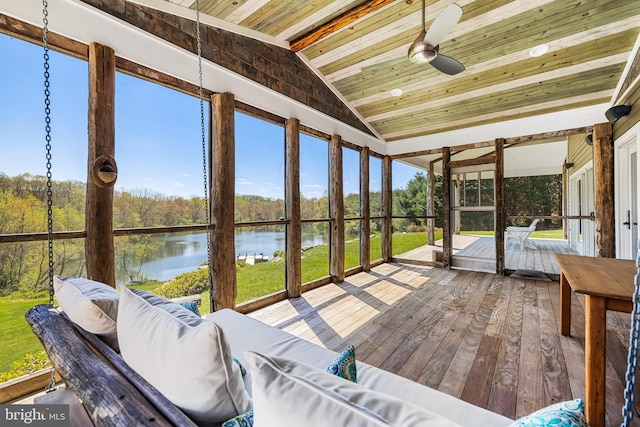 sunroom / solarium with lofted ceiling, ceiling fan, wooden ceiling, and a water view