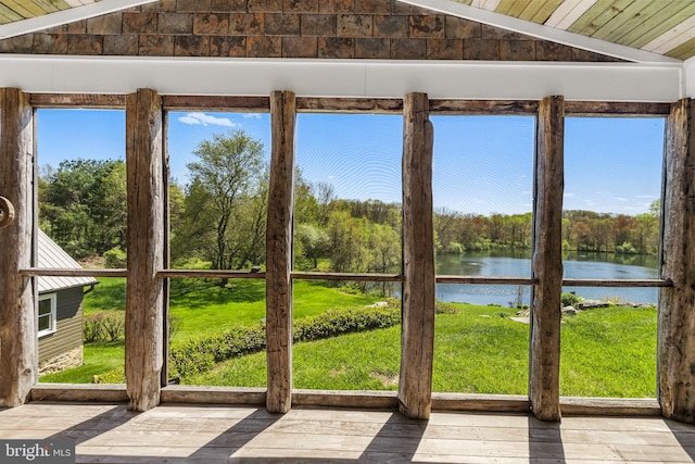 unfurnished sunroom with lofted ceiling, a water view, and wood ceiling