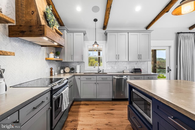 kitchen with backsplash, stainless steel appliances, beamed ceiling, and decorative light fixtures