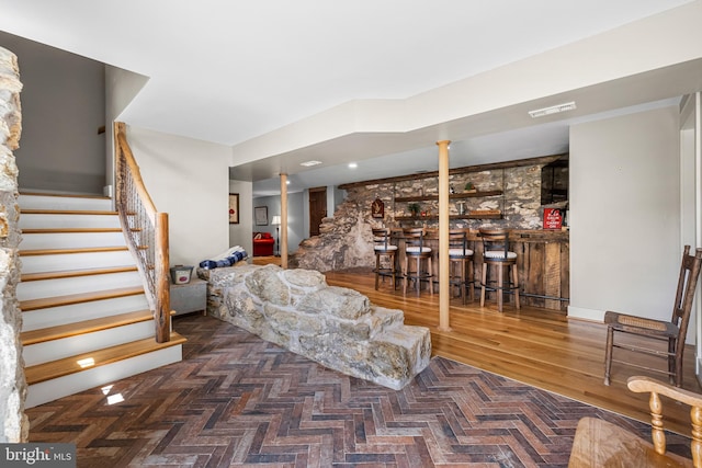 interior space with wood-type flooring and indoor bar