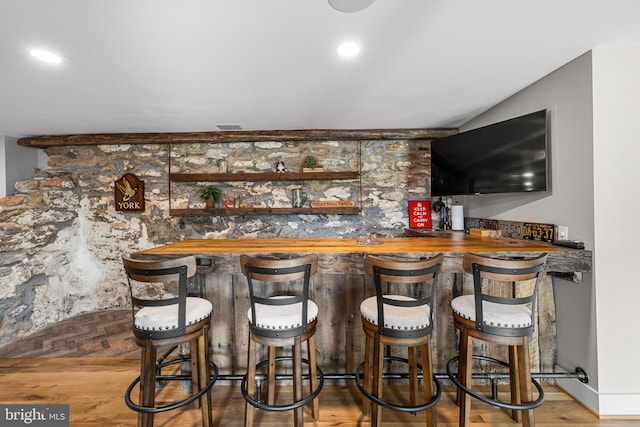 bar featuring hardwood / wood-style flooring