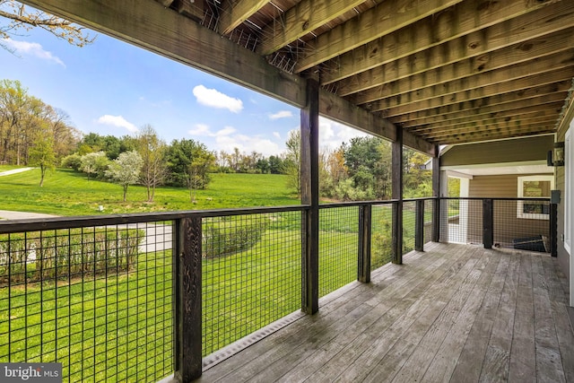 wooden terrace featuring a yard