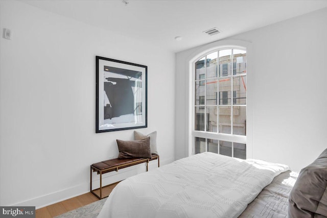 bedroom with hardwood / wood-style flooring