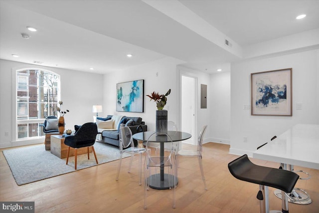 living room featuring light wood-type flooring and electric panel