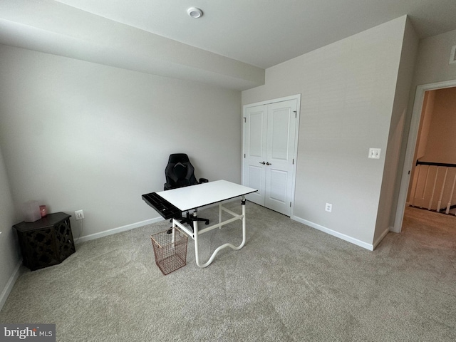 carpeted office space featuring baseboards