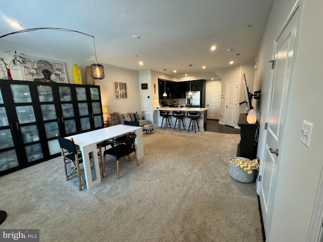 dining area with recessed lighting and dark colored carpet