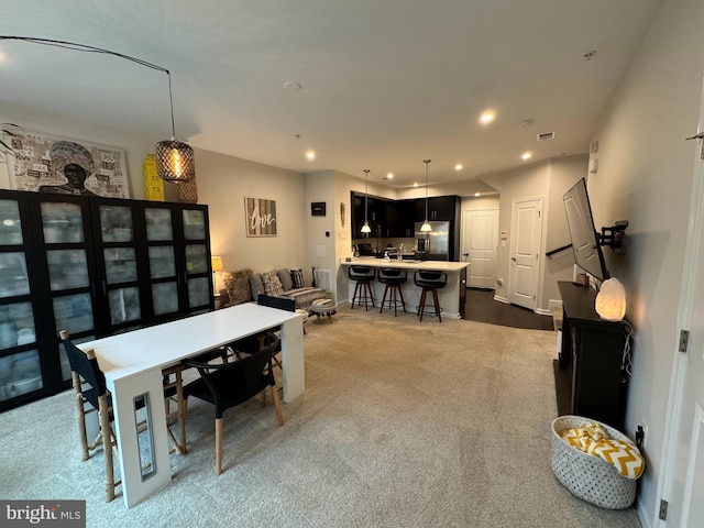 dining area featuring recessed lighting and dark colored carpet