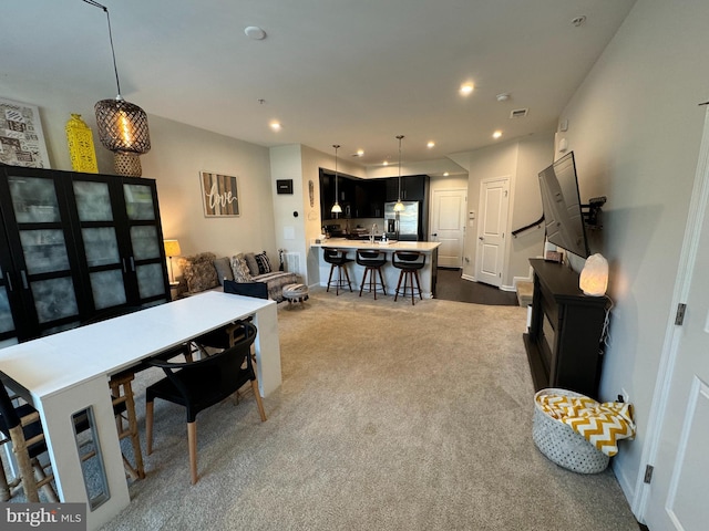 dining space with recessed lighting and dark carpet