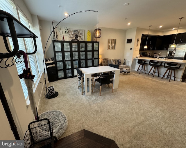 dining area featuring recessed lighting and light colored carpet