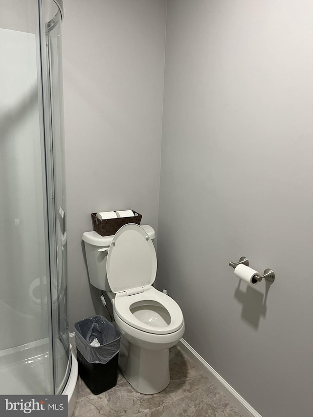 bathroom featuring toilet and tile floors