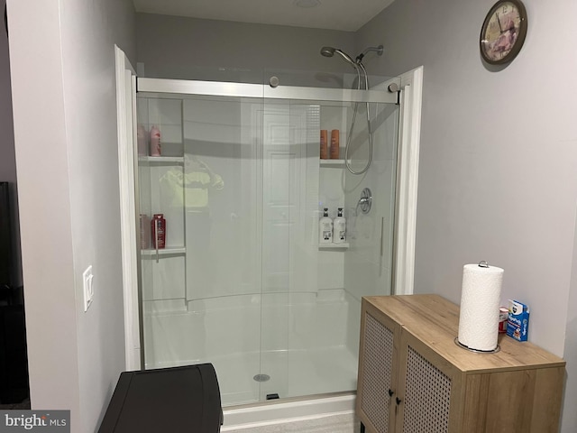 bathroom with a shower with door