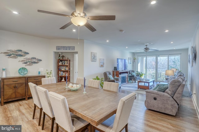 dining area with light hardwood / wood-style flooring and ceiling fan