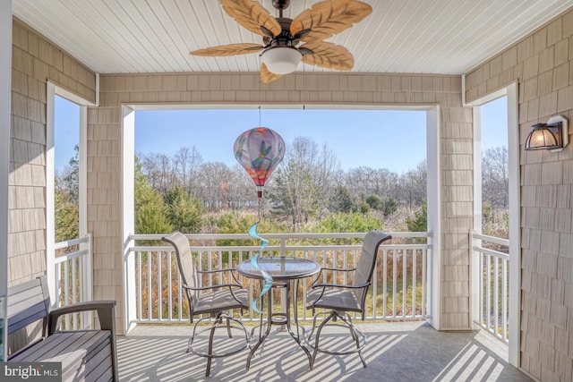 interior space with ceiling fan