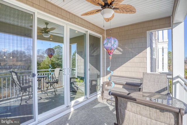 sunroom / solarium with plenty of natural light and ceiling fan