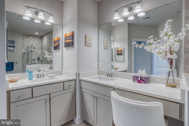 bathroom with double sink, a shower with shower door, oversized vanity, and tile flooring