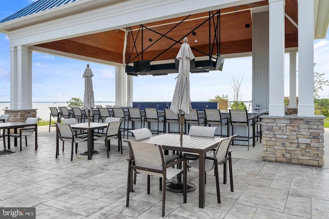 view of patio / terrace featuring a bar and a gazebo