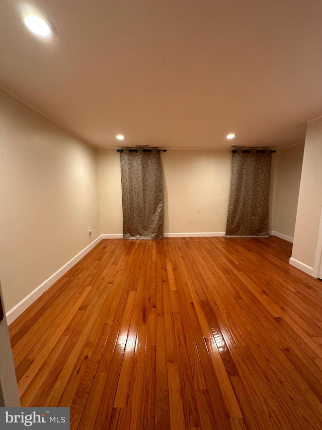 empty room with hardwood / wood-style flooring